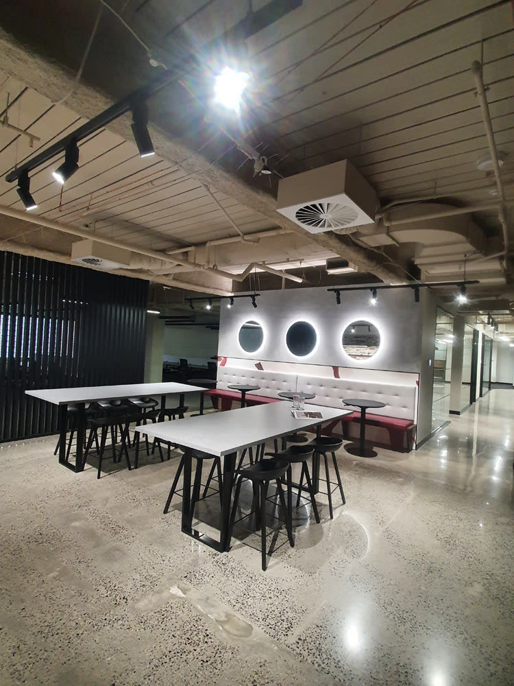 Open-plan tenancy fit-out with exposed services and track lighting