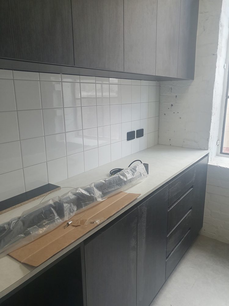 Kitchen bench with timber top and black joinery