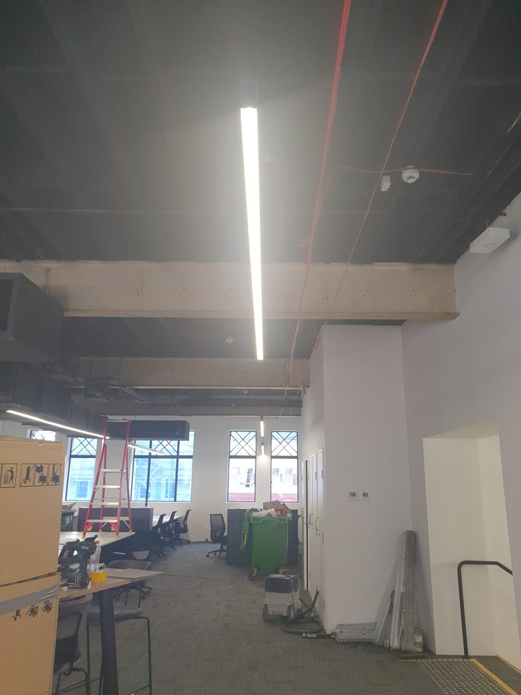 Open ceiling with services run above the grid