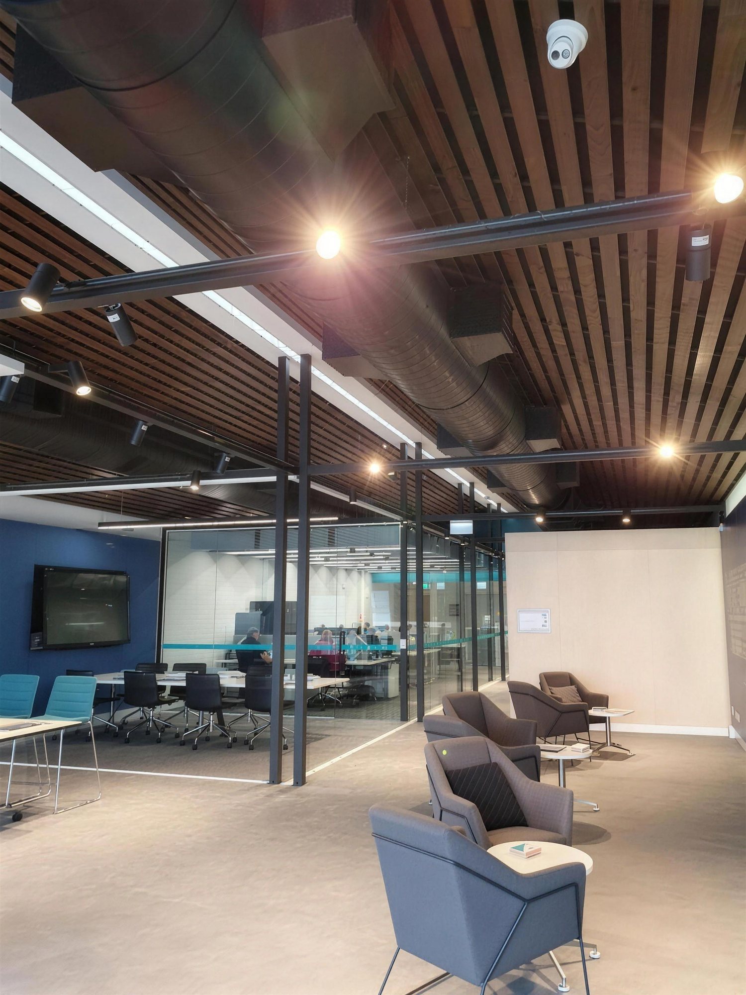 Breakout lounge under a timber-batten ceiling at 108 Elizabeth Street
