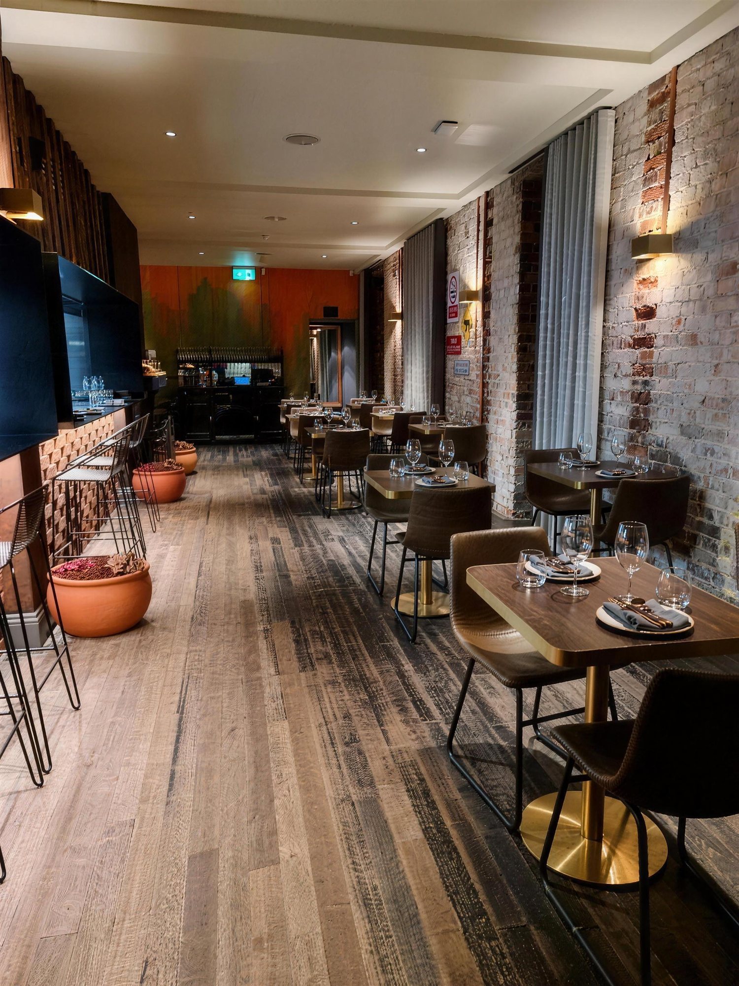 Indu restaurant dining room with timber floor and exposed brick
