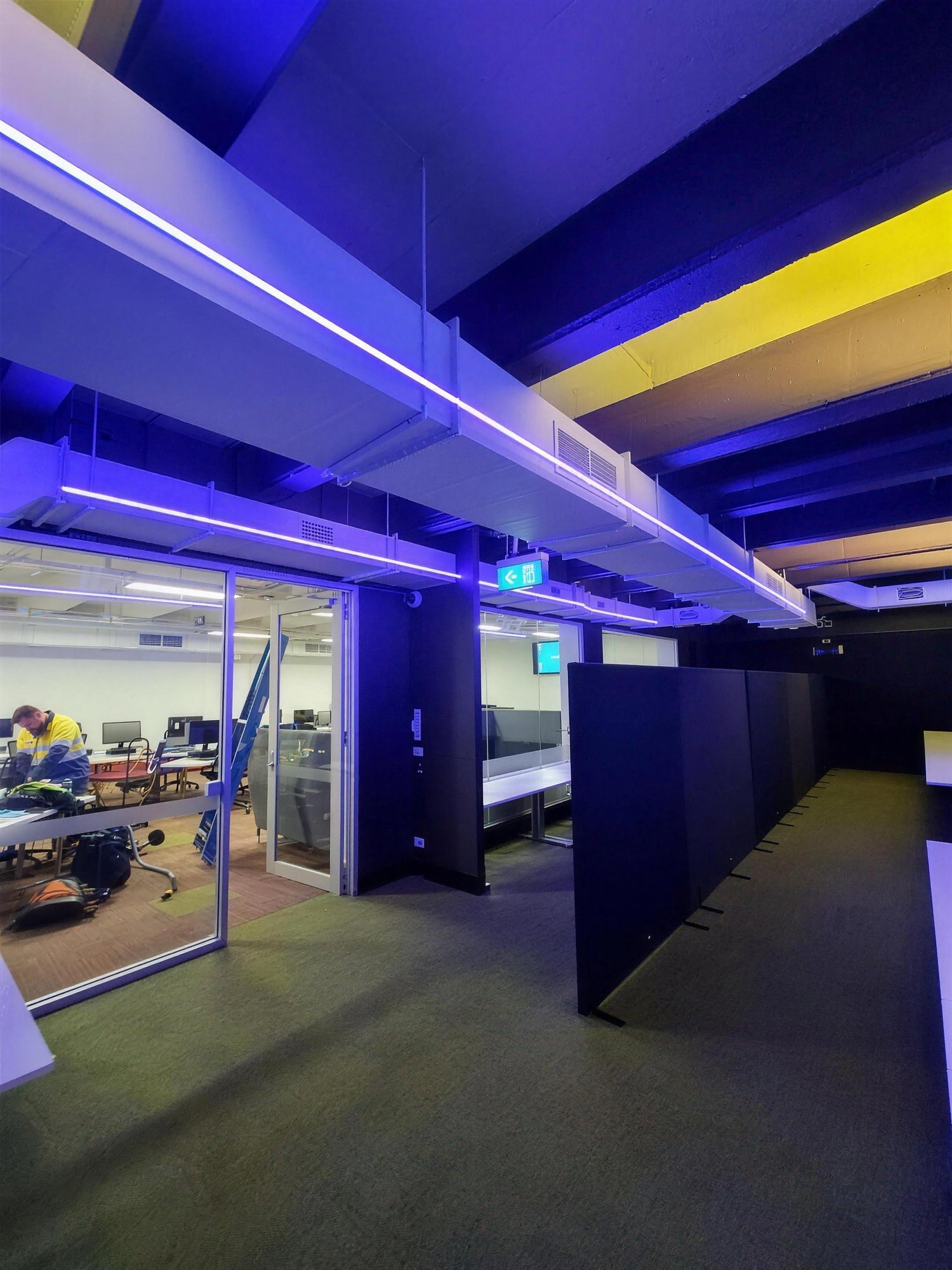 Monash University esports arena lit in purple and yellow
