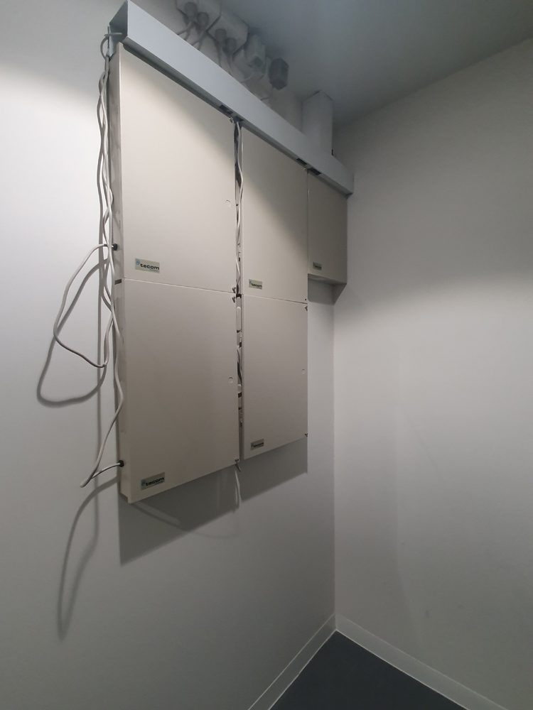 Service riser access panels in a corridor