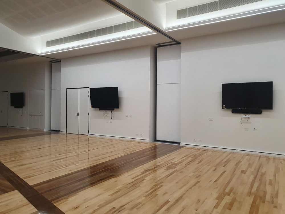 Hall with wall-mounted screens on two walls