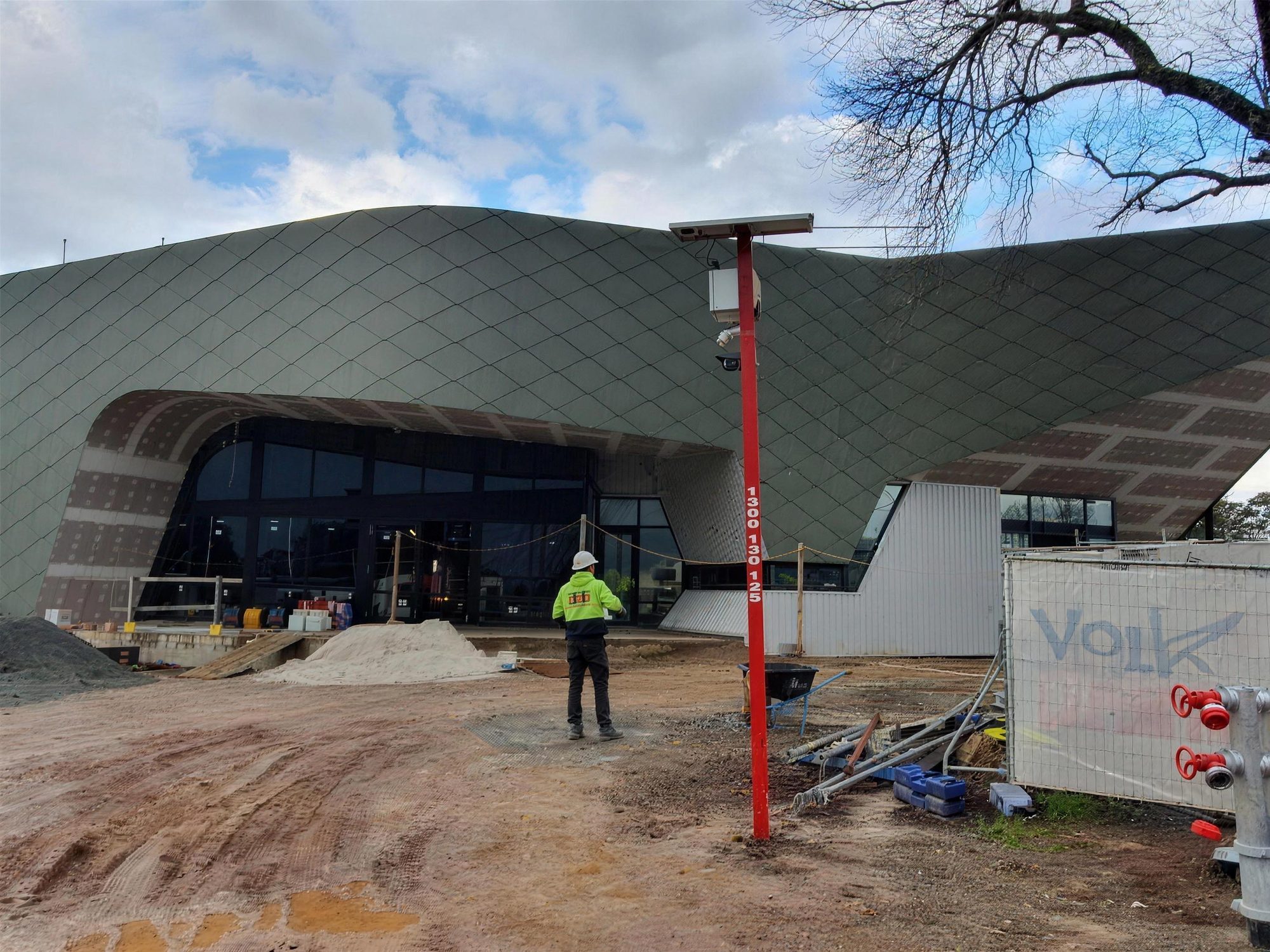 Hills Hub under construction with scaffolding and a site crew