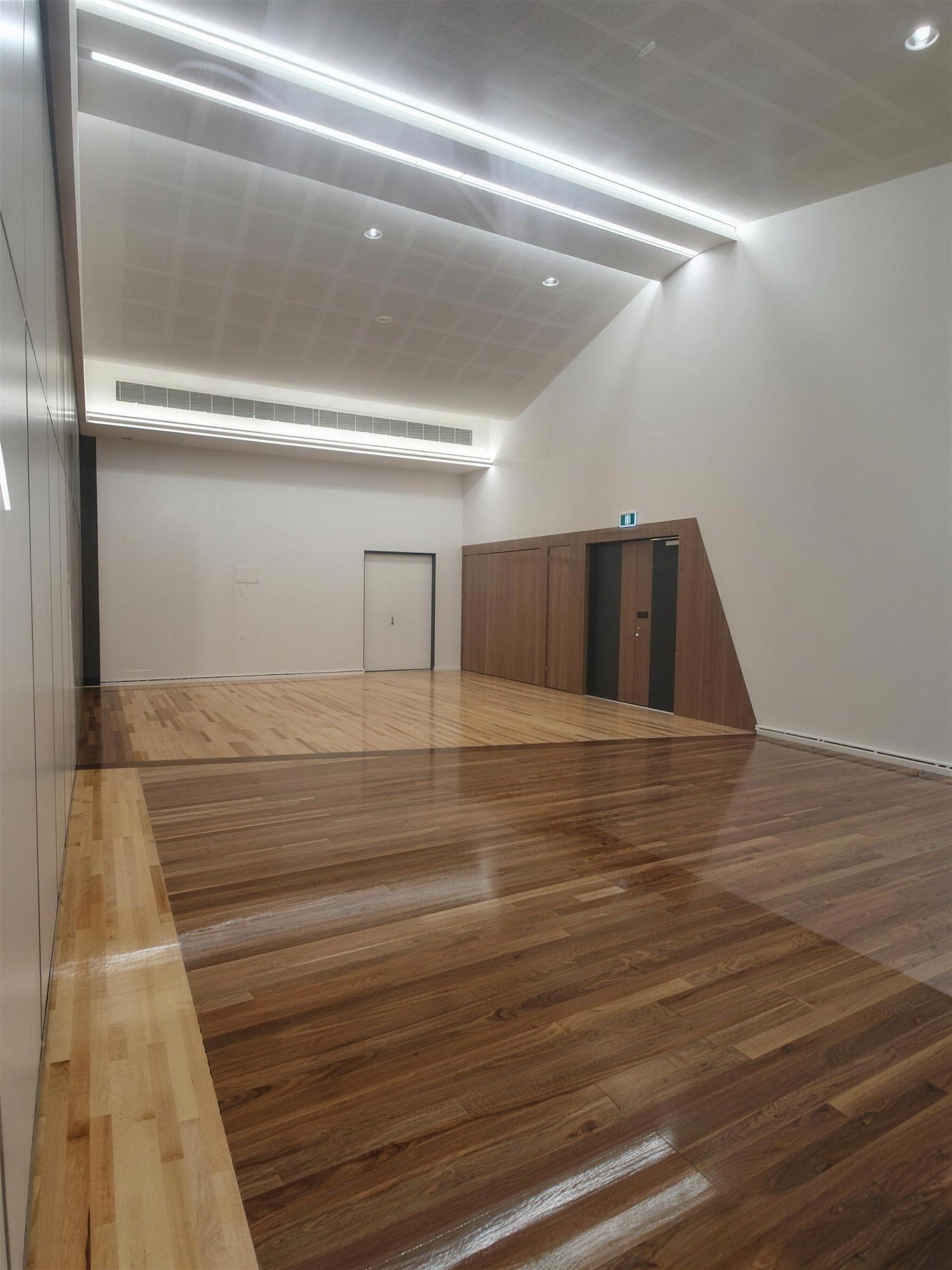 Community hall with polished timber floor and linear ceiling lights